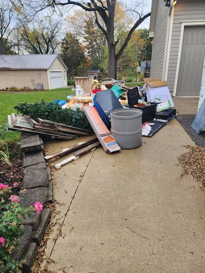 Dumpster being loaded with debris for Roofing Dumpster Rental in Pea Ridge